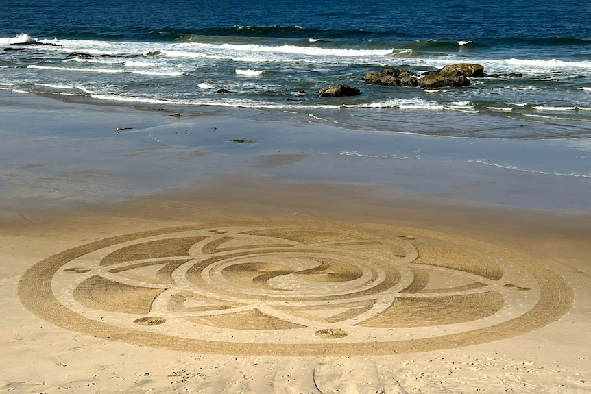 A large circular 'Art in an hour' design on Oxley Beach at Port Macquarie.