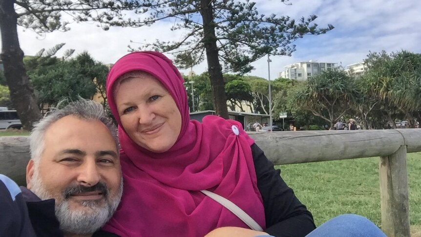 Hazem Hamouda, left, and Evelyn Hamouda pose for a photo in a park.
