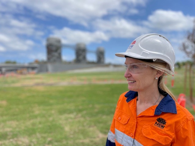 Camilla Drover, wearing a builder's helmet while stood in a park