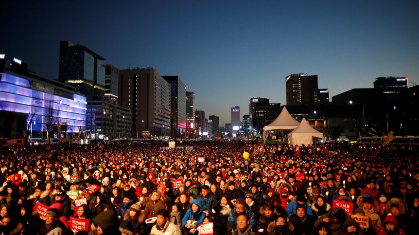 People attend a protest calling for South Korean President Park Geun-hye to step down.