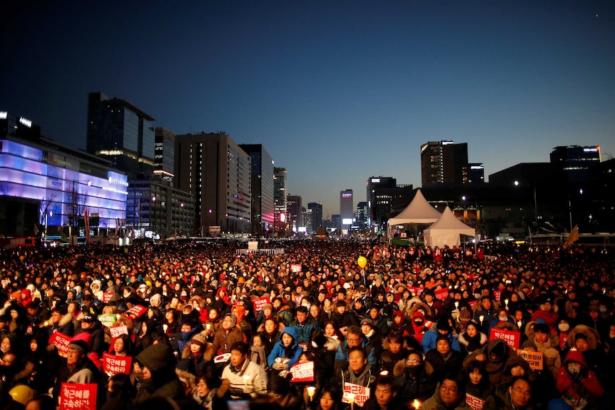 People attend a protest calling for South Korean President Park Geun-hye to step down.