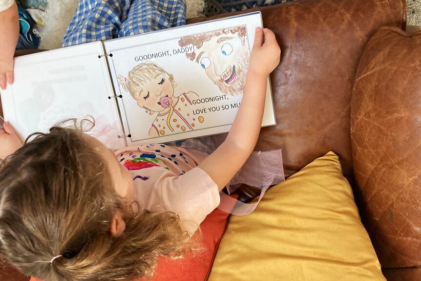 Toddler reading homemade book