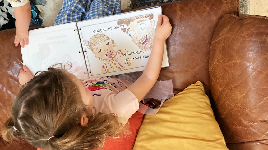 Toddler reading homemade book