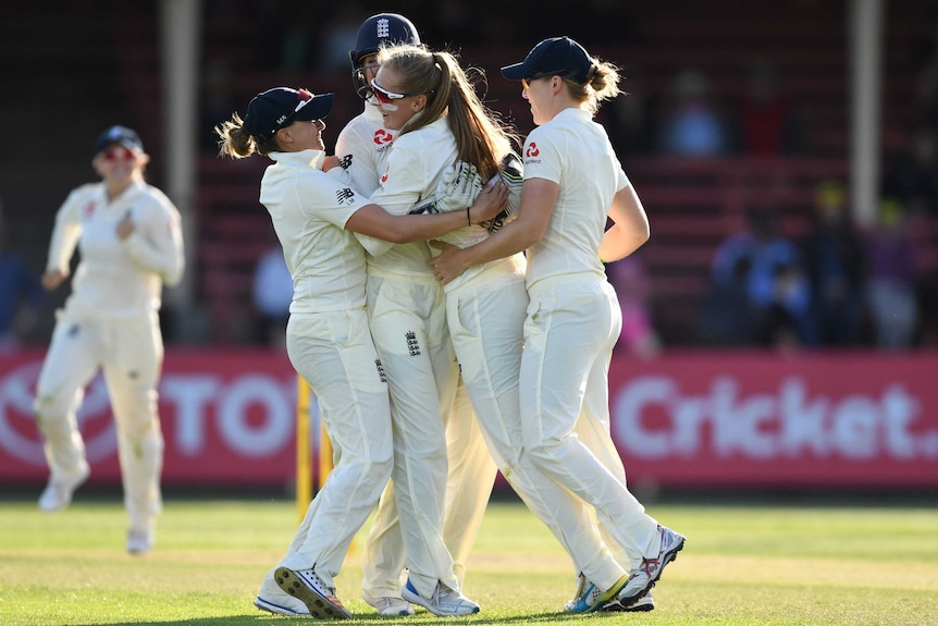 England's Sophie Ecclestone (2R), dismisses Australia's Beth Mooney in the Women's Ashes Test.
