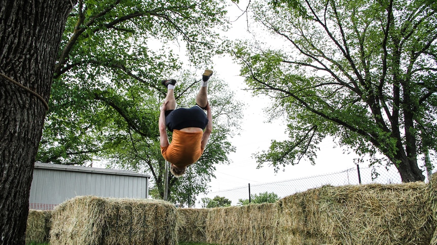 Bendigo parkour instructor Flynn Patreo in a  mid-air somersault.