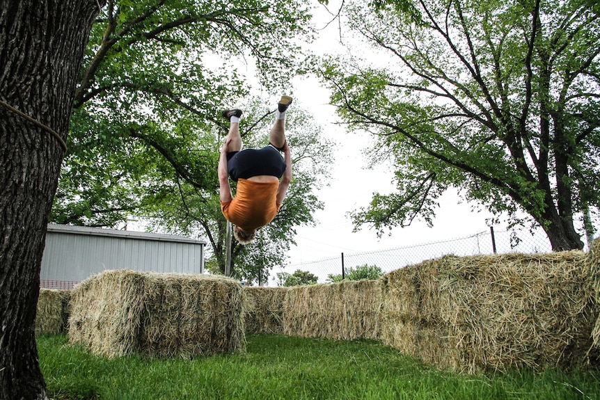 Bendigo parkour instructor Flynn Patreo in a  mid-air somersault.