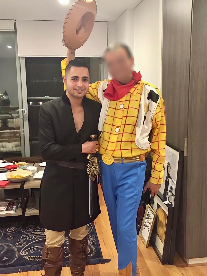 Karan is wearing a musketeer costume. He is standing with a man in a cowboy costume.
