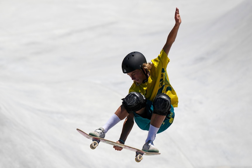 Keegan Palmer of Australia flies through the air on his skateboard at the Tokyo Olympics.