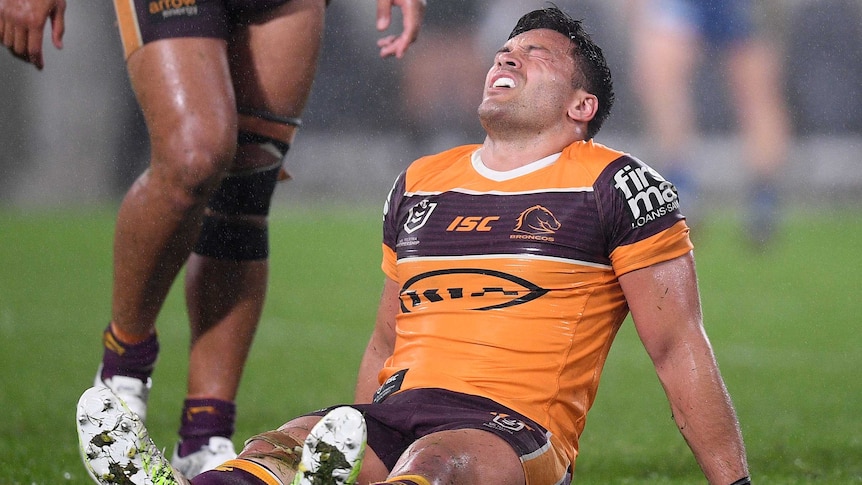 Alex Glenn sits on the ground in the rain as the Brisbane Broncos are beaten by Parramatta Eels in the NRL.