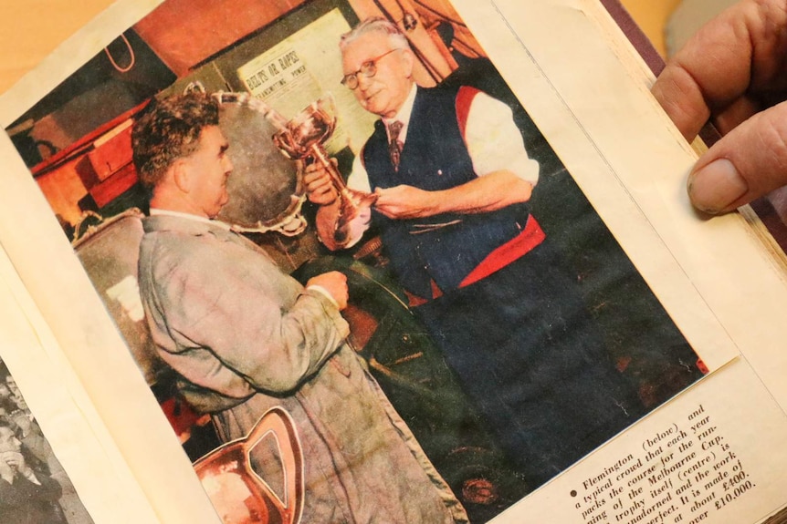 James Steeth passing the Melbourne Cup baton onto his son Maurice as the making gets handed down from a newspaper clipping.