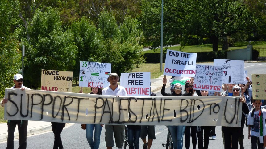 Protesters rally outside the Israeli embassy in Canberra.