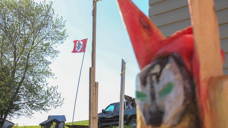 A flag bearing the Nazi swastika on a flag pole