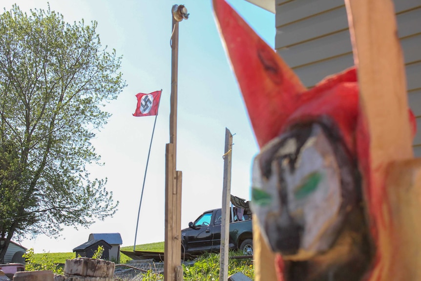 A flag bearing the Nazi swastika on a flag pole