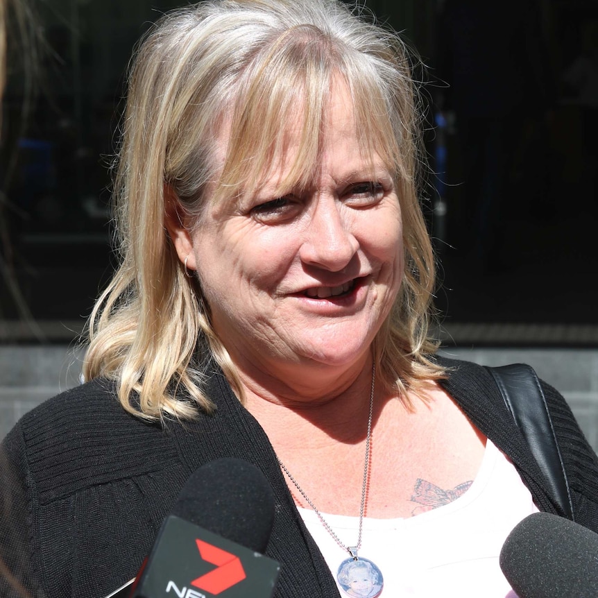 Megan Cammilleri outside the Perth Magistrates court wearing a necklace with a picture of her daughter Jasmine.