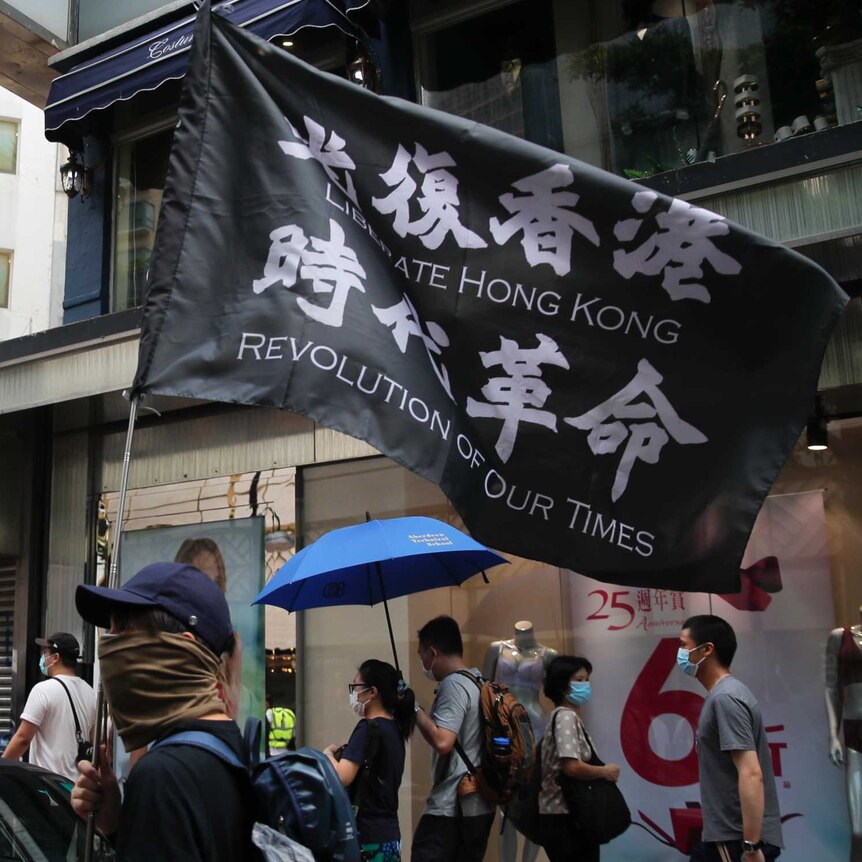 Protesters carry the flag which reads "Liberate Hong Kong, revolution of our time" in Causeway Bay.