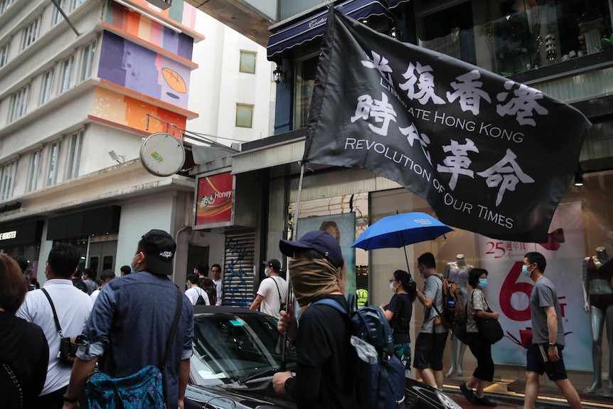 Protesters carry the flag which reads "Liberate Hong Kong, revolution of our time" in Causeway Bay.