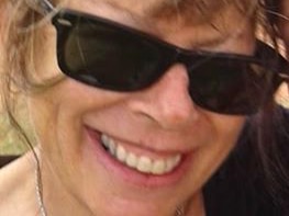 A tight head shot of a smiling Jenni Pratt wearing black sunglasses.