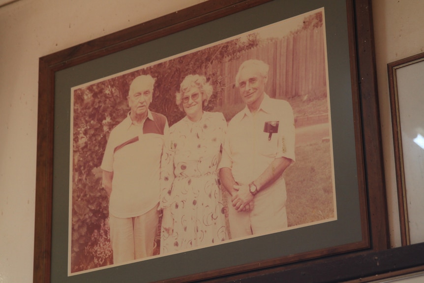 Photo in a frame of three elderley people