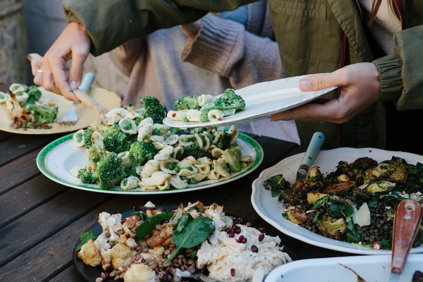 Vegetarian dishes prepared by Hetty McKinnon are served to a group featuring broccoli, Brussel sprouts, cauliflower.