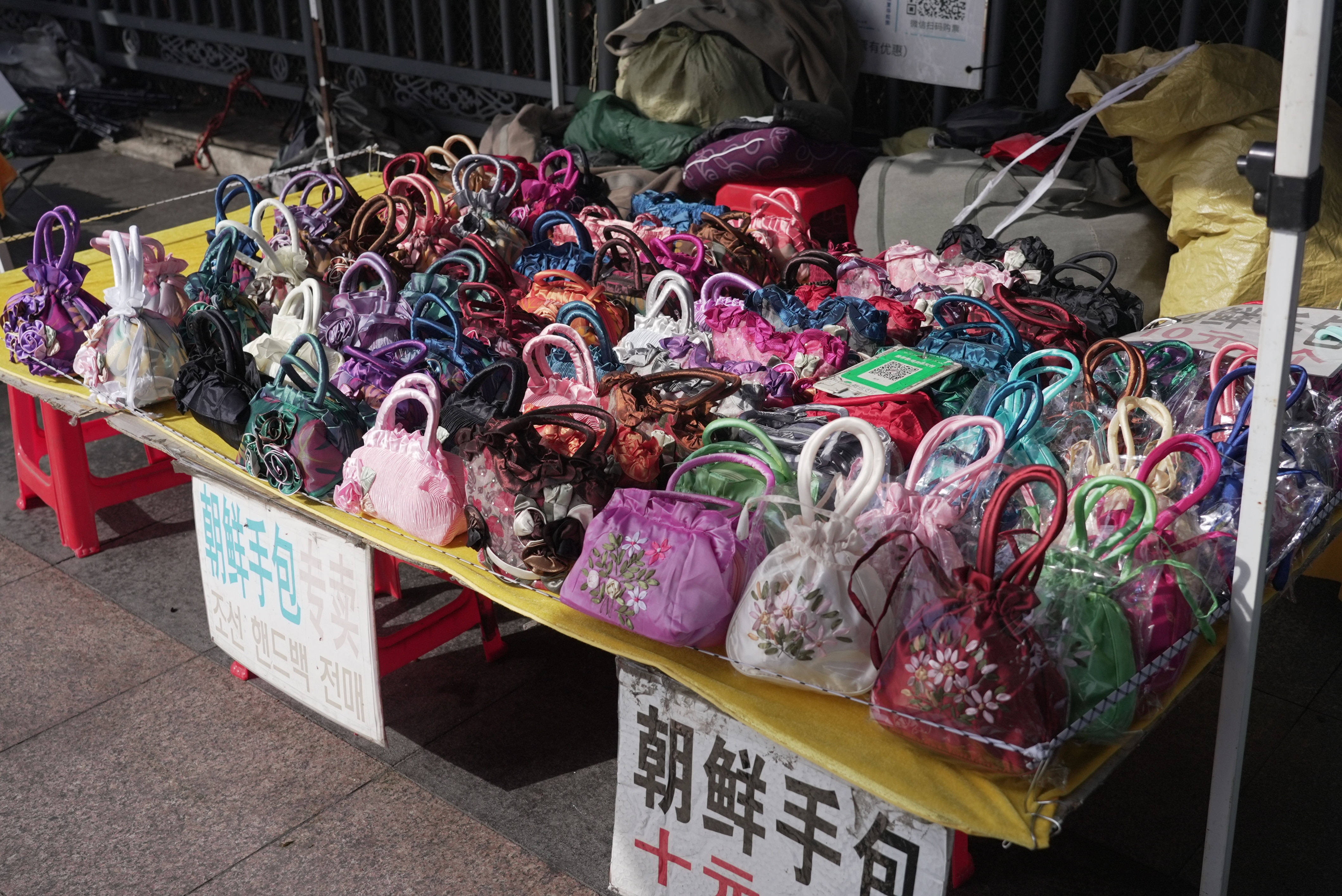 A table laden with purses.