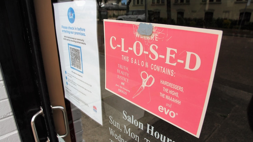 Close up photo of a business sign telling people it's closed