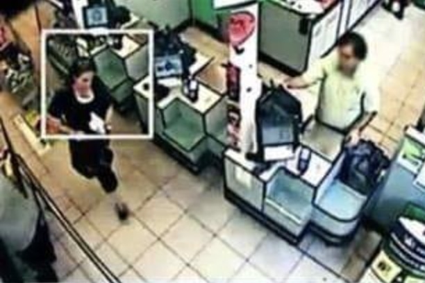 CCTV of a woman wearing black in supermarket.