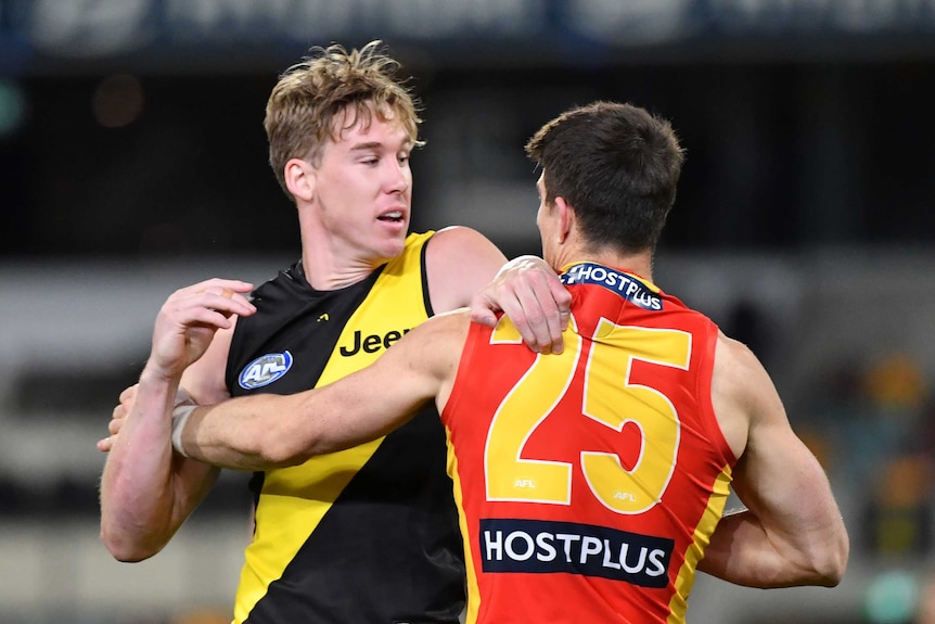 Tom Lynch puts his hands across the shoulders of Sam Collins as the pair face each other