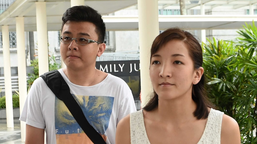 Australian Ai Takag and her Singaporean husband Yang Kaiheng arrive at the court.