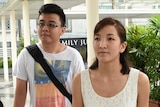 Australian Ai Takag and her Singaporean husband Yang Kaiheng arrive at the court.