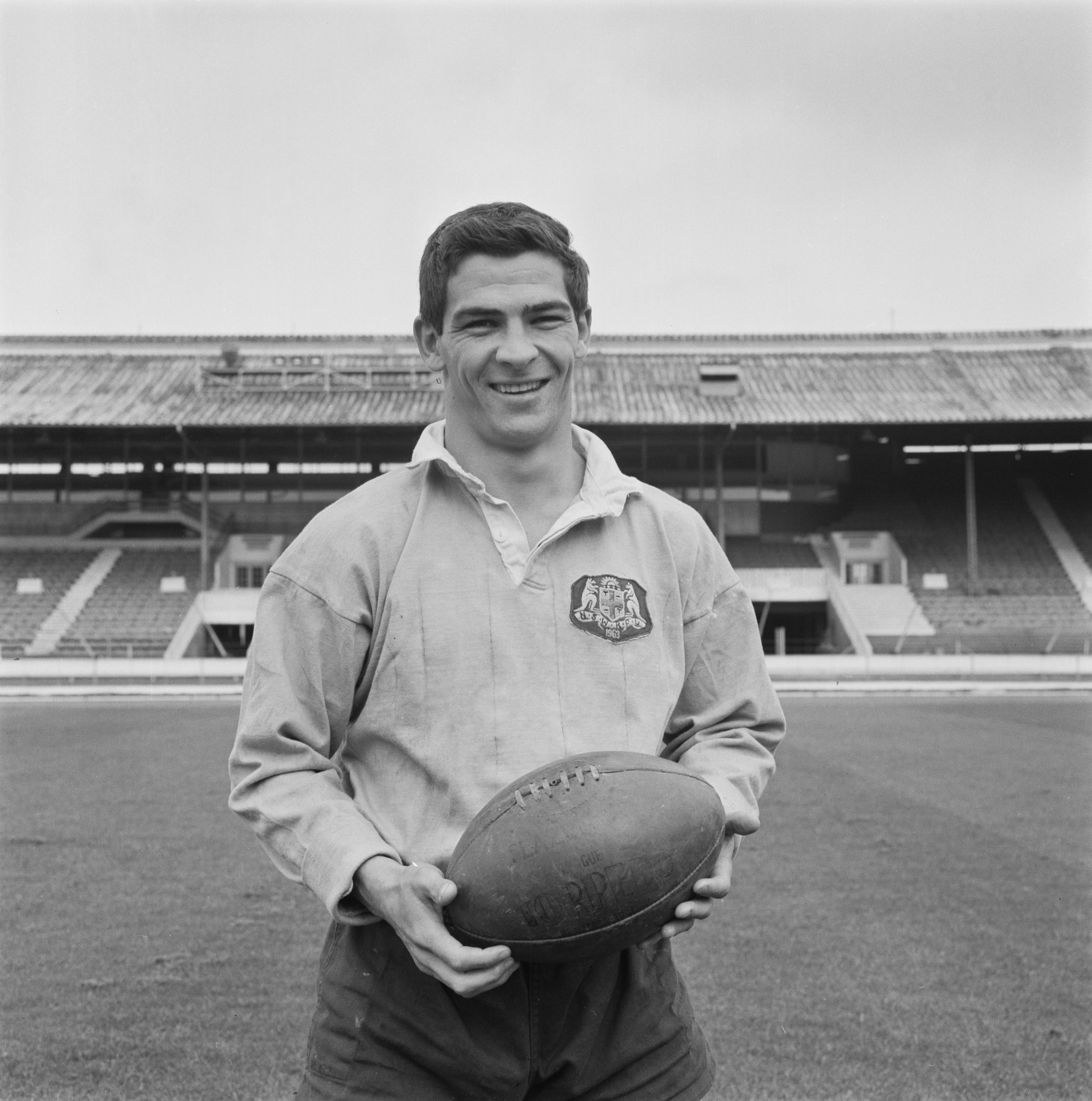 Ken Irvine poses with a football during a training session