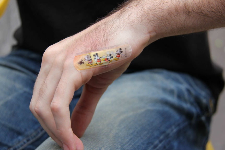 Closeup of a Mickey Mouse bandaid.