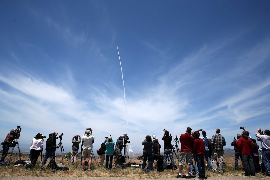 People watch as the ground element of the missile defence system launches into the sky.