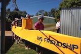 Four competitors in the Henley-on-Todd dry river bed regatta's standing in their yellow submarine.