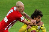 Mooy battles with Riera for possession