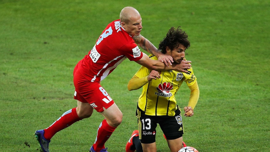 Mooy battles with Riera for possession