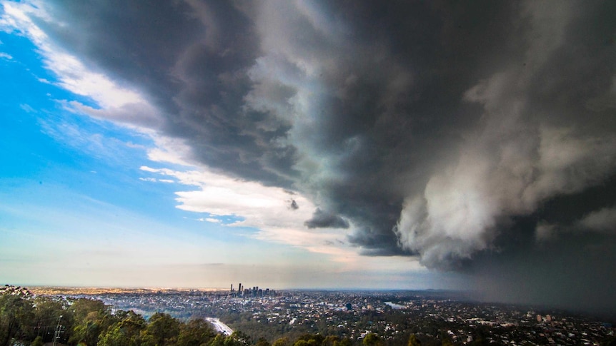 Dark grey ominous clouds move towards Brisbane city