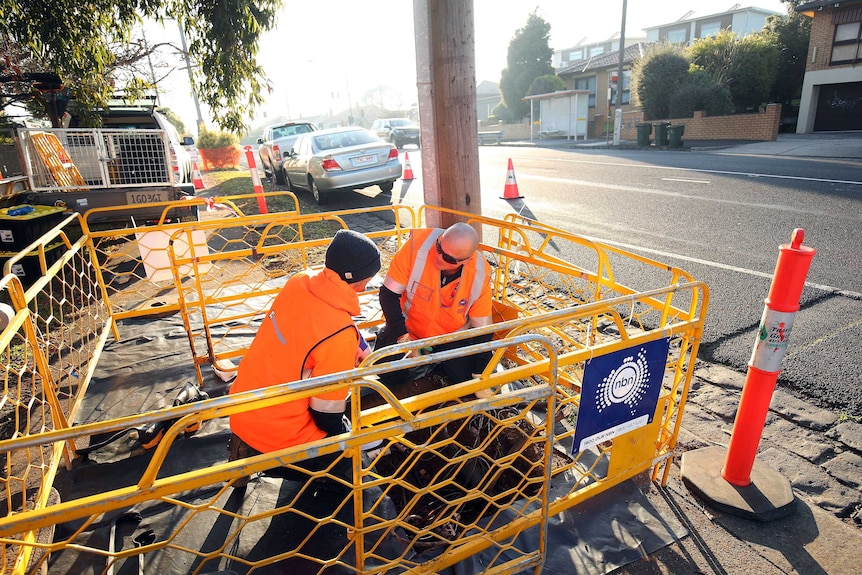 Technicians lay NBN cable in a Melbourne Street.
