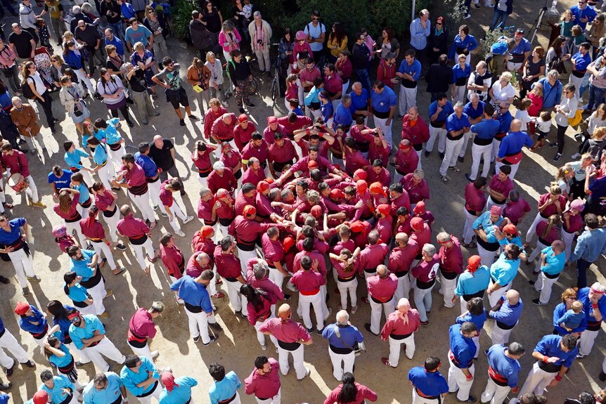 A group of Catalans gather to form human towers.