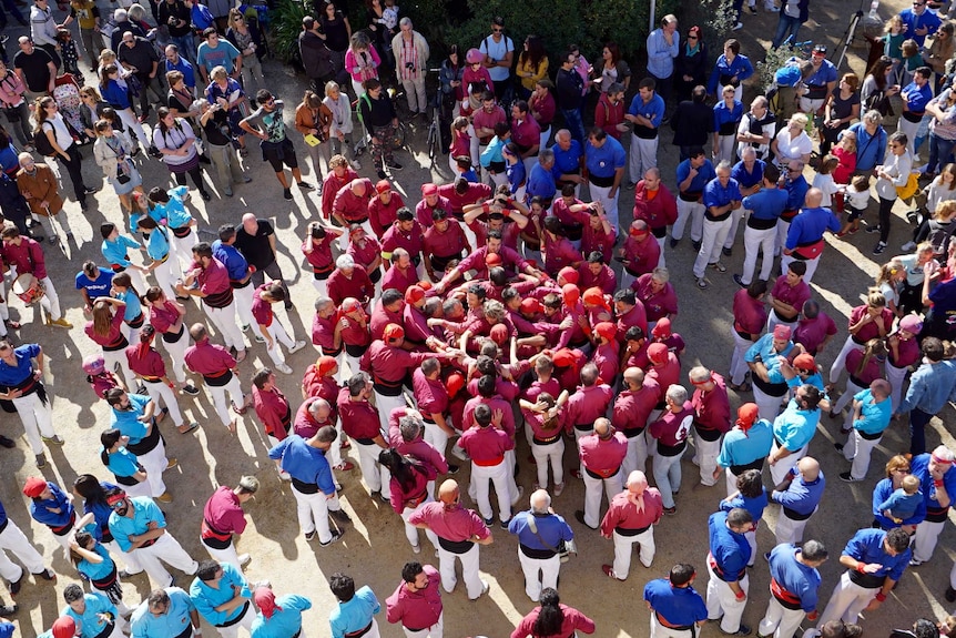 A group of Catalans gather to form human towers.