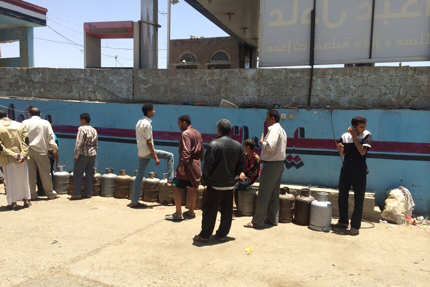 Men queue for gas in Sanaa, Yemen