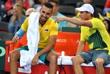 Nick Kyrgios has a laugh as he talks to Lleyton Hewitt at a change of ends during the Davis Cup tie in Brisbane.