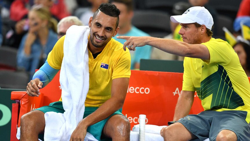 Nick Kyrgios has a laugh as he talks to Lleyton Hewitt at a change of ends during the Davis Cup tie in Brisbane.