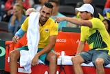Nick Kyrgios has a laugh as he talks to Lleyton Hewitt at a change of ends during the Davis Cup tie in Brisbane.