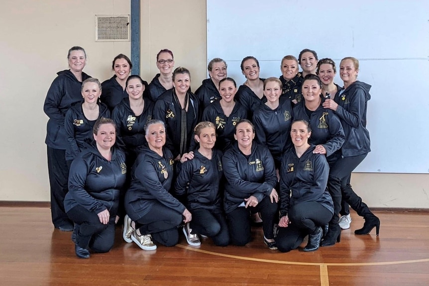 Calisthenics team group shot smiling in track suits