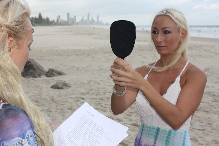 Portrait of Linda Doktar in a dress marrying herself on a Gold Coast beach.