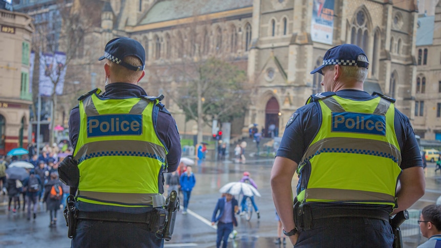 Two police officers at Flinders Street Station in Melbourne.