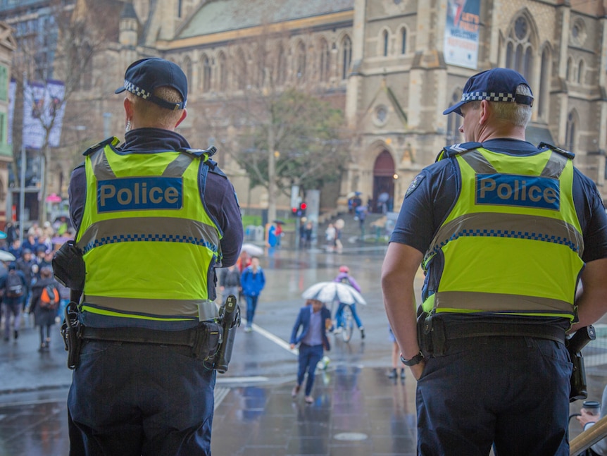 Two police officers at Flinders Street Station in Melbourne.