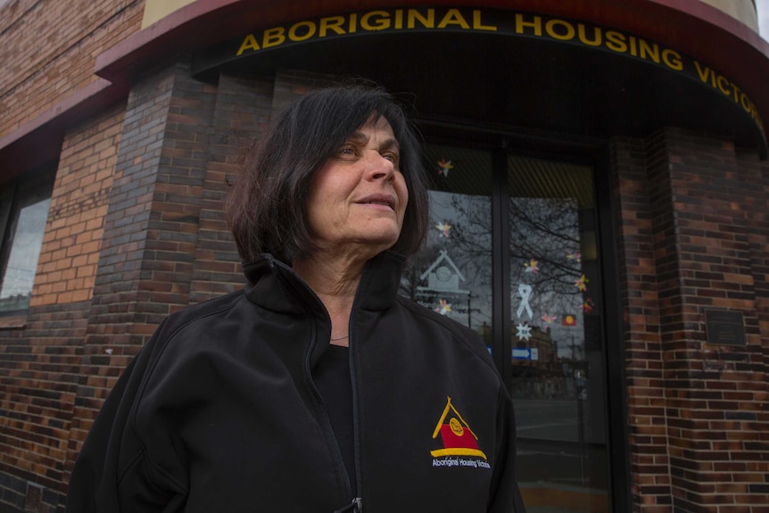 Jenny Samms smiles in front of the Aboriginal Housing  building in Victoria