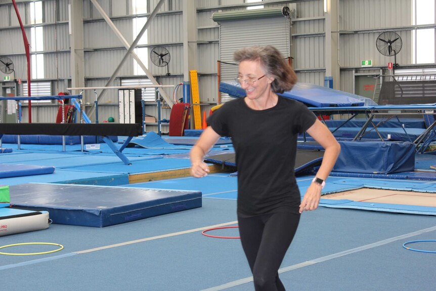 Rosemary Haines running through a gymnasium floor.
