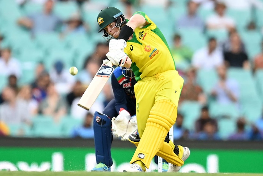 Australia batsman Steve Smith hits a ball down the ground through the air in the second ODI against India.